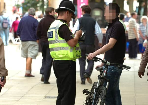 A cyclist being fined in Bridge Street