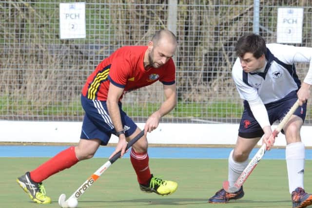 Will Astbury (red) in action for City of Peterborough against Dereham. Photo: David Lowndes.