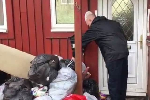 Peterborough Enforcement Officer Roy Clarke inspecting an arson risk caused by the build up of rubbish at a city property.