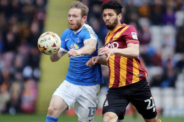 Craig Mackail-Smith battles for possession with Bradford City's Nat Knight-Percival.
