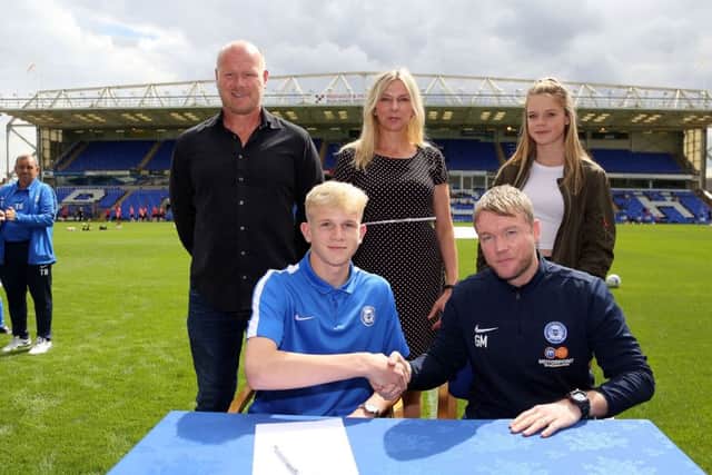 Lewis Freestone signs his Posh professional contract.