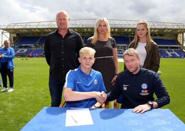 Lewis Freestone signs his Posh professional contract.