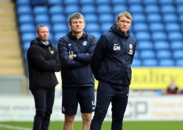 Posh manager Grant McCann (right) and his assistant Lee Glover watch their side slip to defeat against Oxford. Photo: Joe Dent/theposh.com.