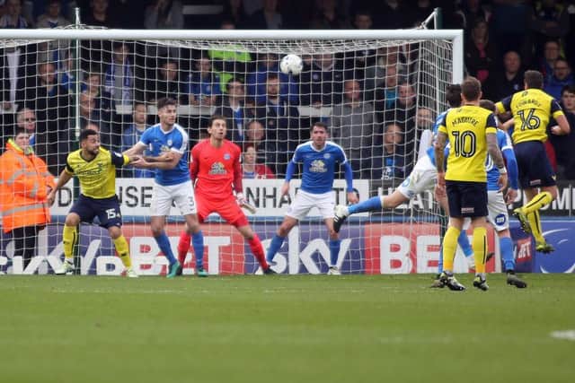 Phil Edwards (16) heads Oxford in front from a corner at Posh. Photo: Joe Dent/theposh.com.