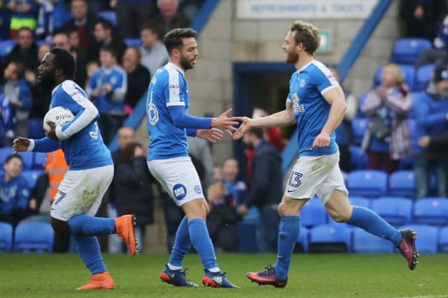 Craiag Mackail-Smith is congratulated by Brad Inman after scoring his 100th goal for the club against Oxford. Photo: Joe Dent/theposh.com.