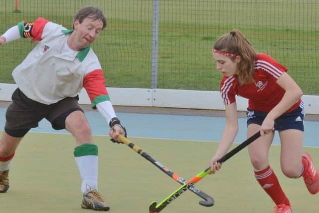Ellie Bolsover of City of Peterborough (red) on the ball against Harborne in the National Mixed Trophy. Photo: David Lowndes.