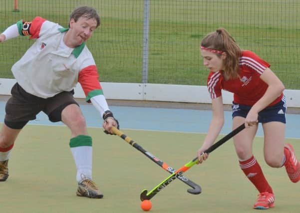 Ellie Bolsover of City of Peterborough (red) on the ball against Harborne in the National Mixed Trophy. Photo: David Lowndes.