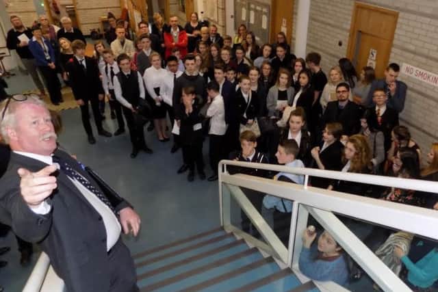 Mr Ian Balmer JP announcing the result of the contest to students from the four schools and fellow magistrates.