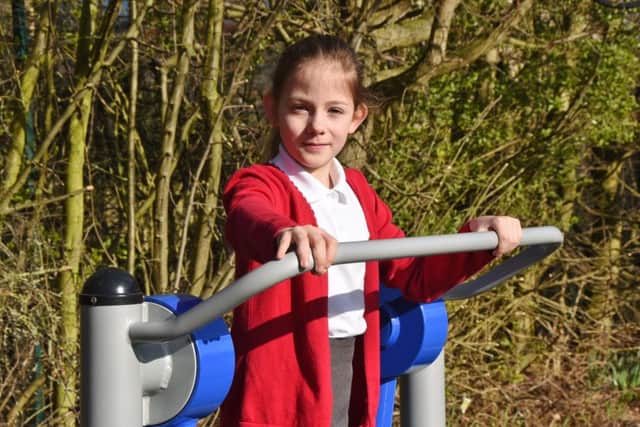 Heritage Park primary school pupils using their new outdoor play/gym equiptment. Pictured is Florence-Lily Gardner EMN-170315-113010009