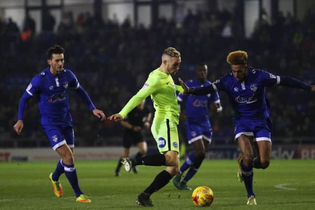 Marcus Maddison of Peterborough United takes on Oldham Athletic's Jamie Reckford - Mandatory by-line: Peterborough United Football Club Ltd / PaperPix- 2016 - 16/17 - FOOTBALL - SportsDirect.com Park - Oldham, Greater Manchester - Oldham Athletic v Peterborough United EMN-170126-095723002