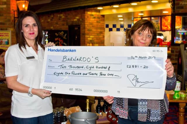 Presenting the cheque is Joanna Green, of Handelsbanken (left), to Lynn McNish, of Barnardos.