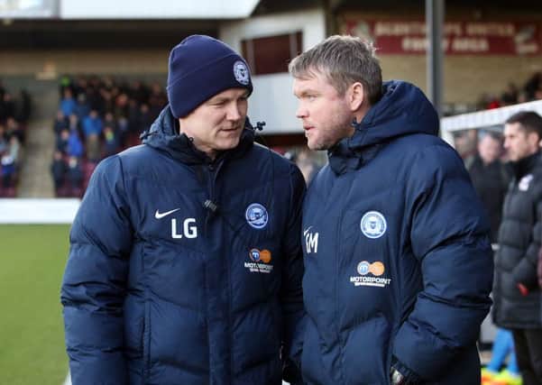 Posh manager Grant McCann (right) with Lee Glover.