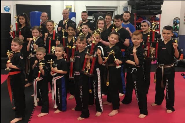 The Hicks Karate team with their trophies. From the left are, back, Elise Ward, David Prior, David Carins, Michael Bulpin, Sarah Ward, Connor Ingrey, middle, Lucy Hicks, Jolie Franks, Shiv Panchal, Aaron Leonard, Chloe Prior, Bevan Prior, Jazmyn Popat Evans, front, Oliver Profit, Joshua Leonard, Tajus Jankauskas, Junior Crozier, Gediminas Saltenis, Denas Jankauskas, Ginge Popat Evans and Braydon Popat Evans.