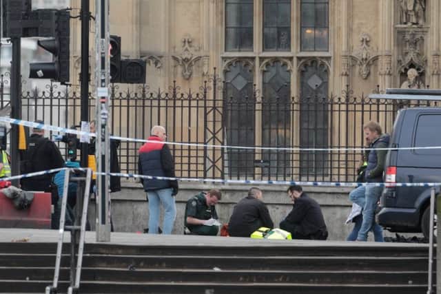 Paramedics on the scene outside the Houses of Parliament where an incident is unfolding, March 22 2107. See National News story NNCOMMONS; Police have reportedly shot a knifeman who stabbed an officer. The House of Parliament has been locked down after the as two men are being treated inside the grounds. Pictures from the scene appear to show a car crashed into railings outside the building just before 3pm. George Eaton tweeted: "Police have just shot a man who was attacking officers at parliament's entrance." SUS-170322-153855003