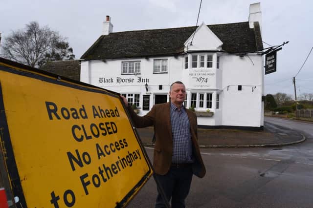 Landlord of the Black Horse, Nassington Gary Johnson with the road closure signs outside his pub EMN-170329-132203009