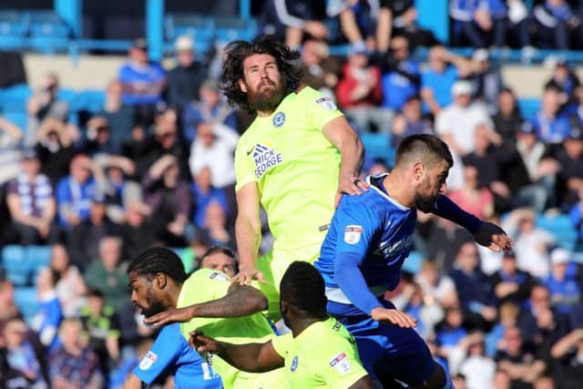 Posh defender Michael Bostwick climbs highest during the 1-0 win at Gillingham. Photo: David Lowndes.