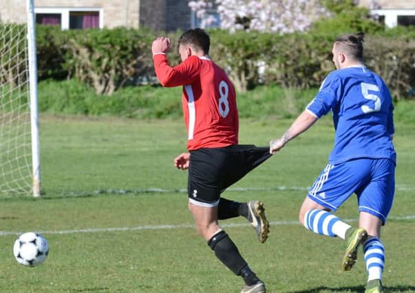 Action from ICA Sports (blue) 2-1 PFA Senior Cup semi-final win over Warboys at Ringwood. Photo: David Lowndes.