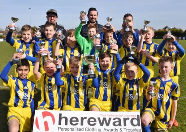 Under 12 League Cup winners Yaxley Blue. They are Lewis Arber, Christopher Brazil, Francis Buckle, Ceri Hayes, Max Hill, Morgan Hossack, Daniel Irving, Harvey Laughton, Adrijan Lutolli, Taylor Roan, Louis Rodrguez, Connor Sanderson, Luke Simpson-Morris, Liam Unalkat and coaching staff Seb Hayes, Mark Arber and Ian Laughton.