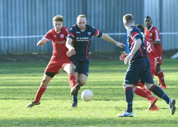 Peterborough Sports striker Mark Jones (left, red) in action in the 3-0 win at Boston Town. Photo: David Dawson.