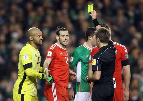 Wales'' superstar Gareth Bale receives a yellow card in the World Cup qualifying game in Dublin.