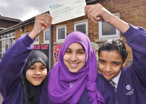 Newark Hill Academy pupil Fatema Damani (11)  who raised Â£142 on her birthday at a bake sale for charity. With her are helpers  Haleema Nadeem (left) and Areebar Asif ( right) EMN-170324-174937009