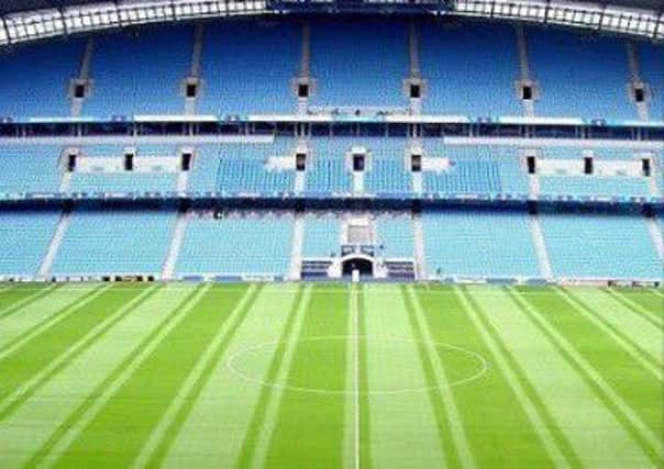 Manchester City's pitch complete with thin blue lines.