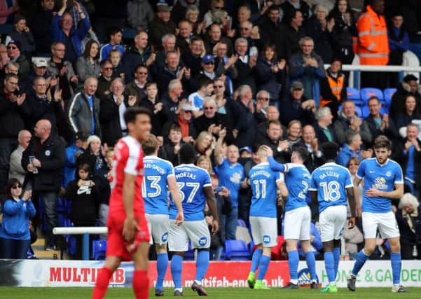 Posh star Marcus Maddison (11) is mobbed by his team-mates after a spectacular goal against Charlton. Photo: Joe Dent/theposh.com.