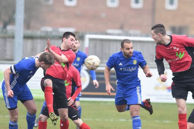 Ollie Medwynter (blue, centre) scored a late winner for Peterborough Sports at Leicester Nirvana.