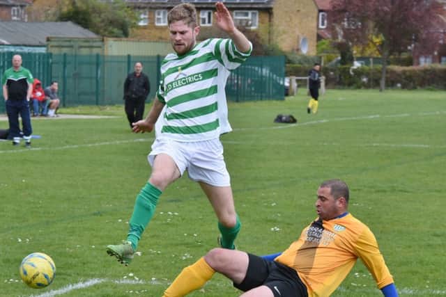 An FC Peterborough defender makes a tackle on an Eye striker in their Peterborough League Division Three clash. Photo: David Lowndes.