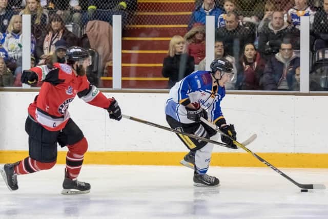 Owen Griffiths carries the puck around Bison's Daniel Lackey. Picture: Tom Scott