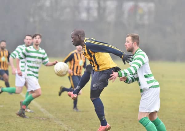 Bretton North End's Fernand Bass (yellow) could be a key man in the Northants Area Cup Final against Brotherhood Sports.
