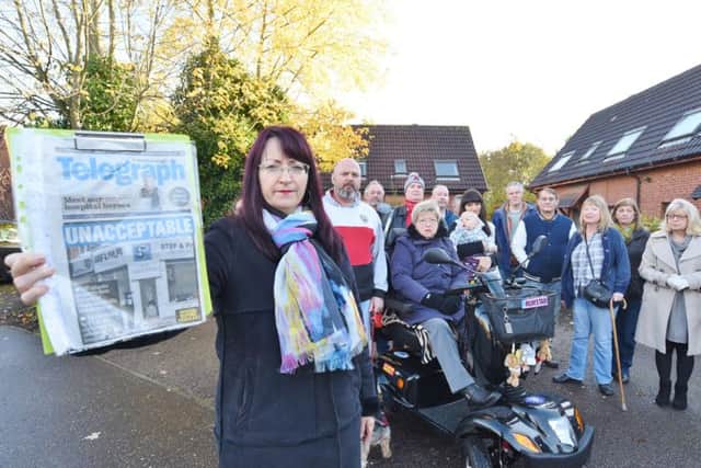 Residents of St Michael's Gate with a copy of the Peterborough Telegraph EMN-161113-172443009