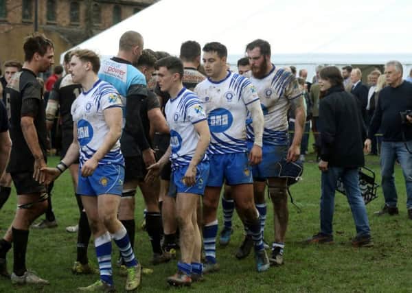 Dejected Lions players shake hands with their Bridgnorth opponents. Picture: Mick Sutterby