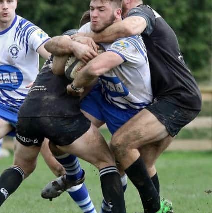 Tom Lewis is collared by a Bridgnorth opponent. Picture: Mick Sutterby
