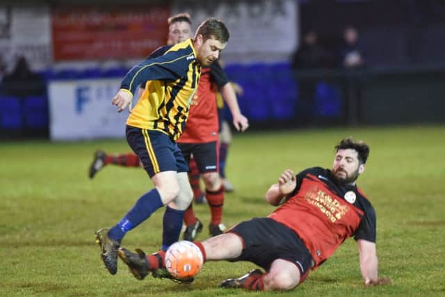 Kenny Martin of Bretton North End rides a challenge from Brotherhood Sports centre-back Ben Underwood. Photo: David Lowndes.