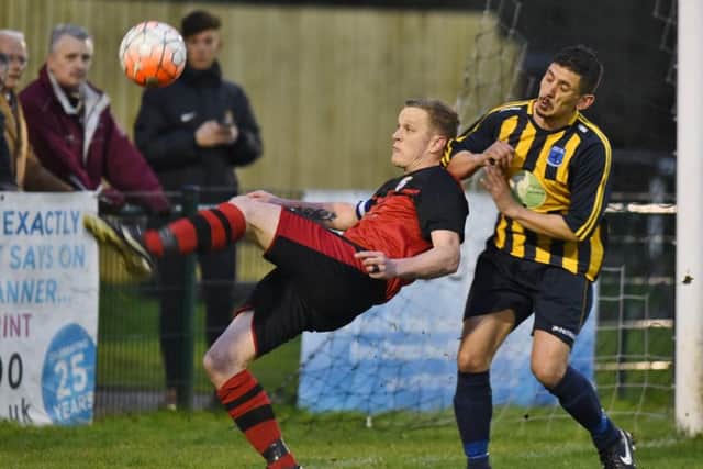 Brotherhood Sports full-back Michael Halfhide clears under pressure from Bretton North End's Ricky Rozario. Photo: David Lowndes.