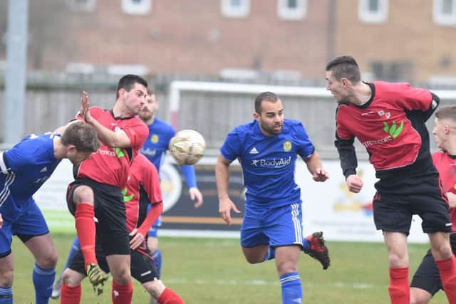 Olly Medwynter (centre, blue) scored the winning goal for Peterborough Sports at Desborough last weekend.