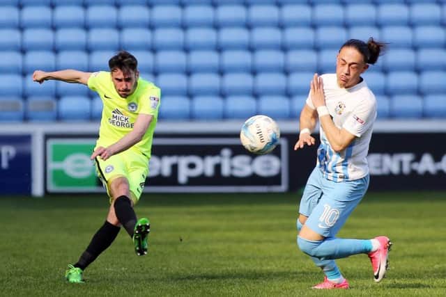Michael Smith of Peterborough United clears the ball away from Jodi Jones of Coventry City. Picture: Joe Dent