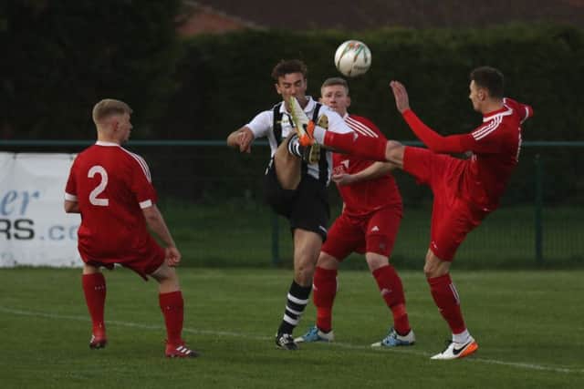 Action from Peterborough Northern Star v Wisbech Town. Jake Mason (stripes) is the Northern Star player Photo: Tim Gates.