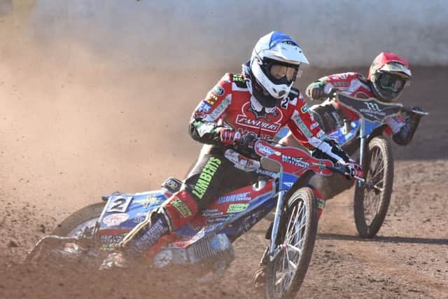 Panthers' Simon Lambert (blue helmet) aleads Jack Holder (red in heat one against Redcar. Photo: David Lowndes.