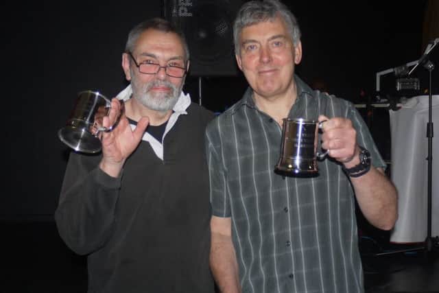 Tim Needham (left) and Ray Church with their commemorative trophies.