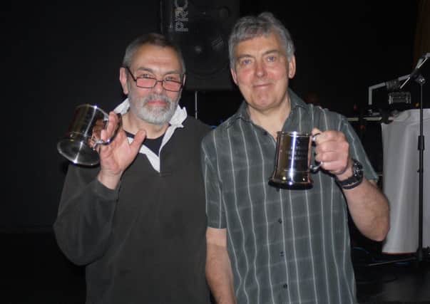 Tim Needham (left) and Ray Church with their commemorative trophies.