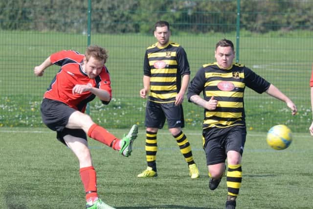Action from Ramsey's 6-1 win against Netherton United A (red) at the Grange. Photo: David Lowndes.