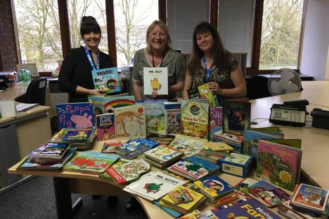 Staff at BGL with some of the books donated to schools.