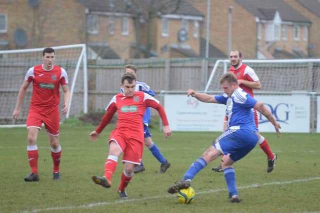 Karl Gibbs (blue) will be a key man for Peterborough Sports Reserves against Pinchbeck.
