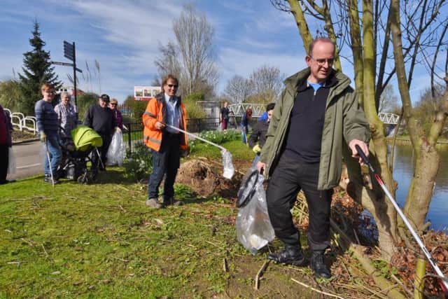 Coun. Andy Cole with volunteers cleaning up the area around the River Nene near Railworld. EMN-170325-195225009