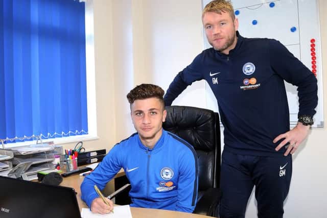 Andrea Borg puts pen to paper watched by Grant McCann. Picture: Joe Dent