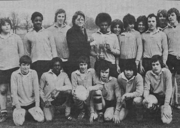 Pictured 40 years ago is the Eastholm rugby team that retained the Peterborough Secondary Schools  Cup by beating Walton 9-4 in the final at the Old Showground. Their skipper Trevor Quow kicked all their points and is seen receiving the trophy from dashing ET rugby writer Bob French. The rest of the team was  Mark Sawyer, Carmen Tsang, Lloyd Mendez, Stephen Wagg, Paul Woods, Gary Parker, Ray Taggart, Andrew Robson, Phillip Allen, Robert Sergeant, Martin Fitzjohn, Kevin Wilkinson, Dave Rawlings and Dave Shaw.