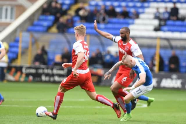 Posh star Marcus Maddison is knocked over by the Fleetwood defence. Photo; David Lowndes.