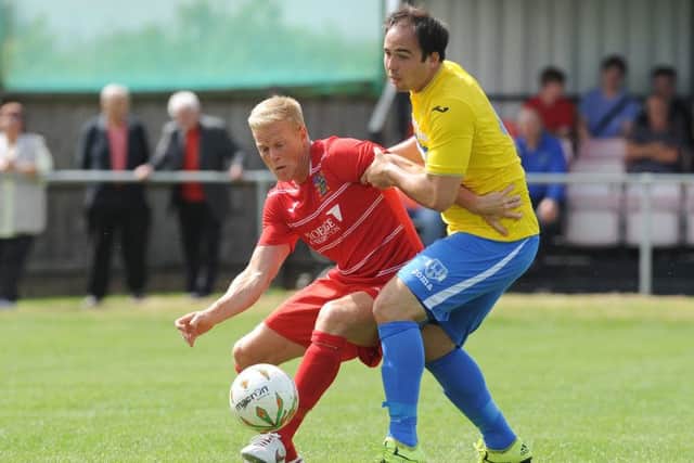 Michael Frew (red) scored for Wisbech against Sleaford.
